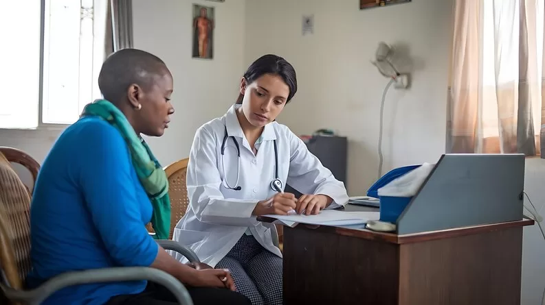 freepicdownloader.com female doctor is writing down her patient what feel better medium Leading Healthcare Consulting Across Cameroon