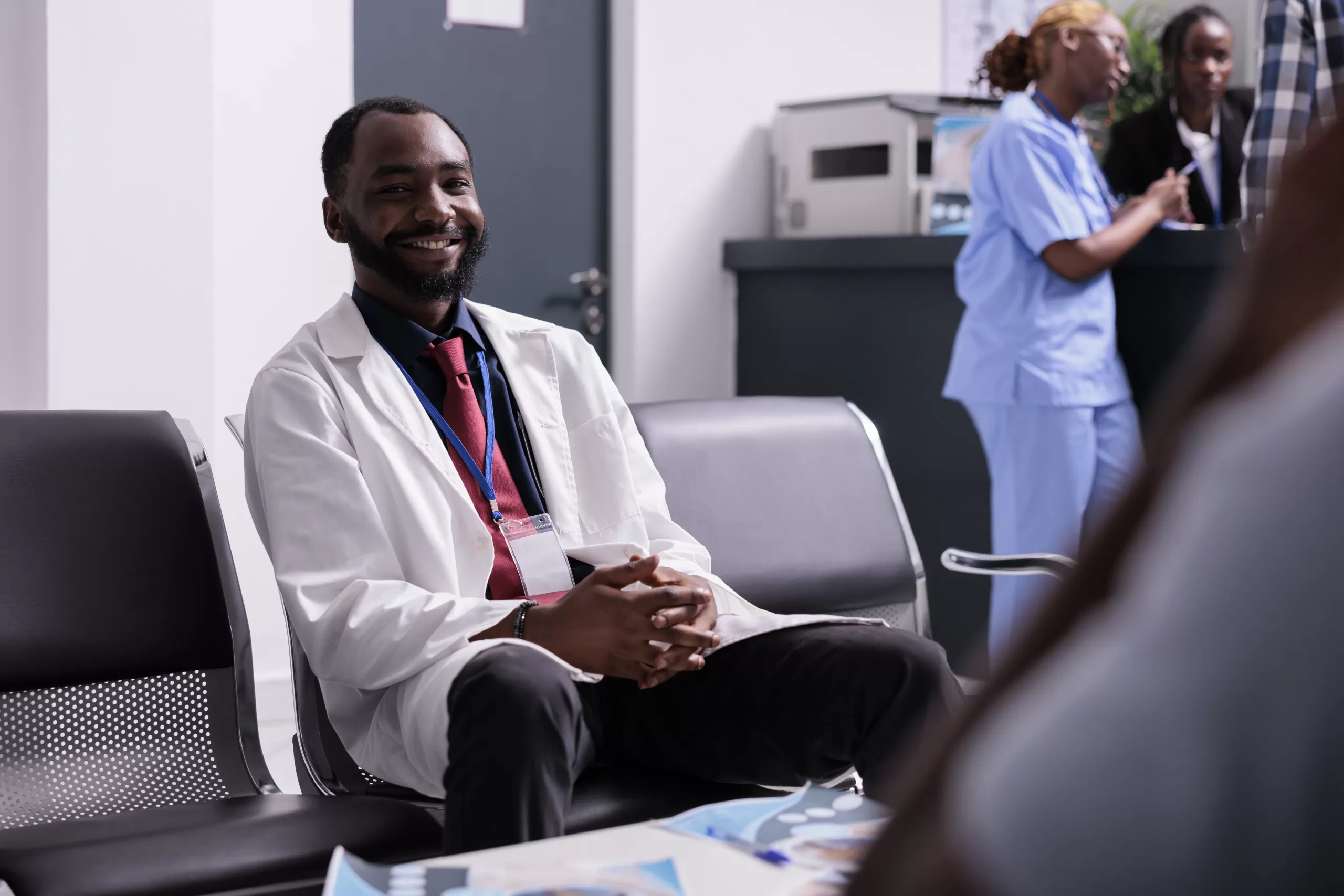 portrait african american doctor lobby sitting waiting room seats before having medical consultation appointment with patients general practitioner working healthcare center scaled Leading Healthcare Consulting Across Kenya